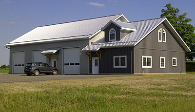 A finished small horse barn with attached outbuilding for equipment by Dutch Masters Construction